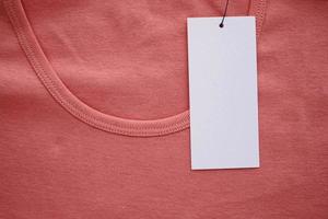 Blank white clothes tag label on new shirt photo