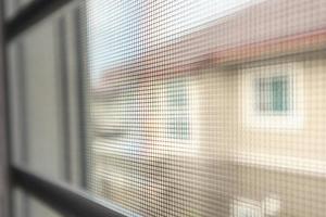 mosquito net wire screen on house window protection against insect photo