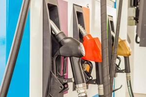 Petrol filling nozzles at gas station pump photo