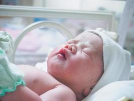 new born baby infant sleep in the incubator at hospital photo