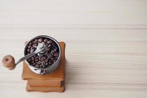 Vintage manual coffee grinder with roasted coffee beans photo