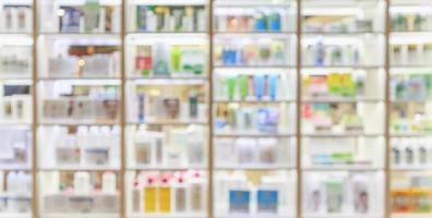 medicines healthcare product and cosmetics arranged on shelves in the pharmacy blurred defocused background photo