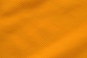 vista superior de textura de camiseta de fútbol de jersey de tela de ropa deportiva de color naranja foto