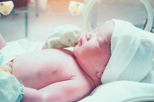 new born baby infant sleep in the incubator at hospital photo