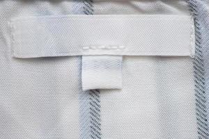 Blank white clothes label on new shirt photo