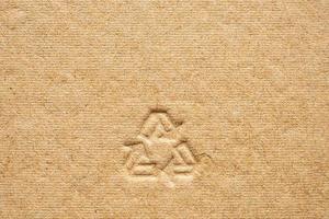 recycle sign on brown cardboard paper texture background photo