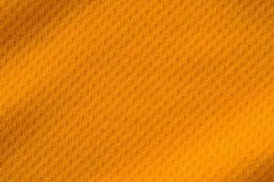 Orange color sports clothing fabric jersey football shirt texture top view photo