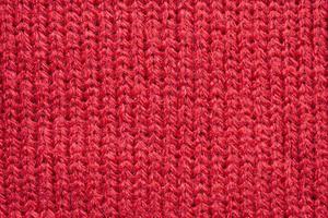 Red knitted wool fabric texture background photo