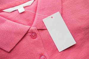 Blank white clothes tag label on new shirt photo