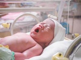 new born baby infant sleep in the incubator at hospital photo