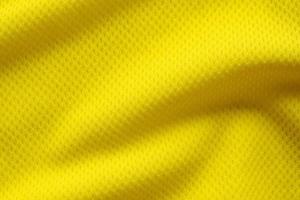 Yellow color football jersey clothing fabric texture sports wear background, close up photo