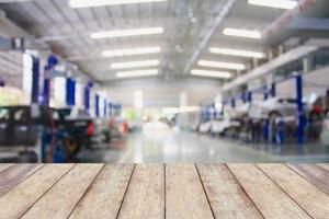 Wood table top with blur garage background photo