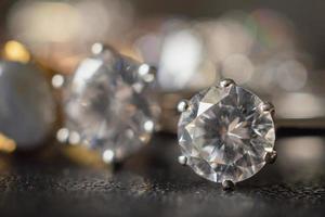 Jewelry diamond rings set on black background close up photo