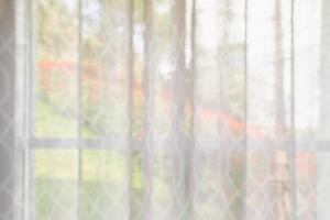 window curtain with green garden abstract blur background photo