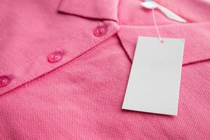 Blank white clothes tag label on new shirt photo