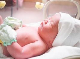 new born baby infant sleep in the incubator at hospital photo