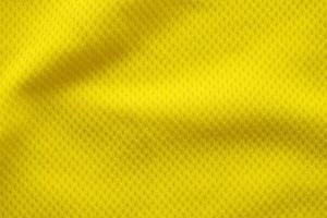 Color amarillo camiseta de fútbol ropa tela textura ropa deportiva fondo, primer plano foto
