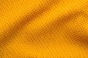 Orange color sports clothing fabric jersey football shirt texture top view photo