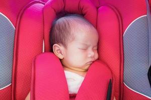 newborn baby sit in the car seat for safety photo