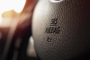 Safety airbag sign on car steering wheel with horn icon photo