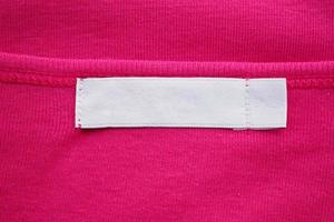 Blank white clothes tag label on new shirt photo