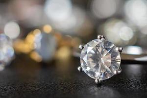 Jewelry diamond rings set on black background close up photo