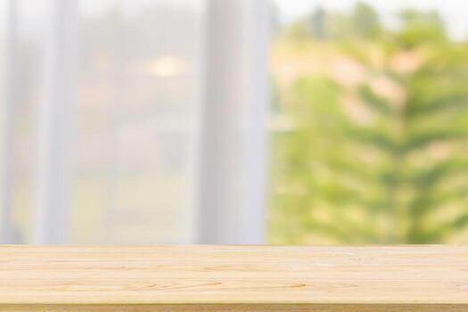 Empty wood table top with window curtain abstract blur background for product display photo