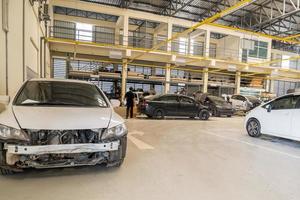 Broken car in auto repair service workshop photo