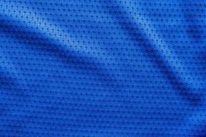 Blue color fabric sport clothing football jersey with air mesh texture background photo