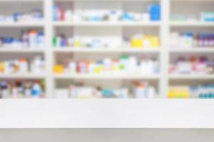 pharmacy counter with blur shelves of drug in the pharmacy drugstore background photo