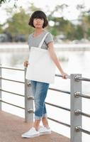 hipster woman with white tote bag in the park photo