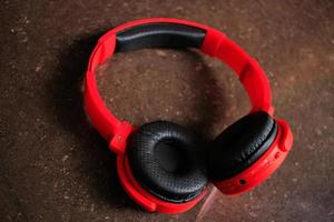 A sophisticated bluetooth headset, red color and attractive appearance makes many people love a headset like this photo
