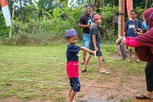 Blitar, Indonesia - September 11th 2022 A boy who is encouraged by his parents in the Indonesian Independence Day competition in Blitar photo