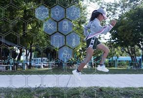 Sporty woman runner in shadow on a natural background, image of attractive woman in modern sportswear, dynamic movement, side view, sports and a healthy lifestyle. photo