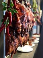 Roast Ducks Hanging in a Showcase photo