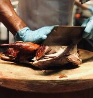 Chef butcher cutting Roast duck Pro Photo