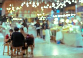 Abstract of blurred people in food court photo