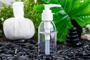 Cosmetic bottle for essential oils on black stone photo