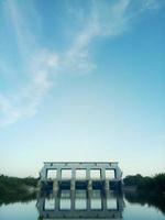 sluice in the morning against the background of a clear sky. the beauty of the river in the morning photo