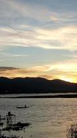 Silhouette of a man fishing in the afternoon. sunset on lake Limboto, Indonesia photo