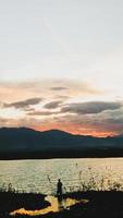 Silhouette of a man fishing in the afternoon. sunset on lake Limboto, Indonesia photo