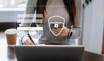Cyber security concept, Login, User, identification information security and encryption, secure access to user's personal information woman using smart phone and tablet in office photo