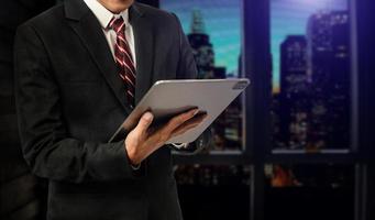 Close up image of business man holding a digital tablet online banking, internet network communication concept photo