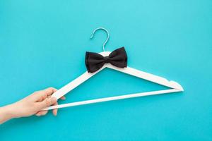 White wooden hangers on blue background photo