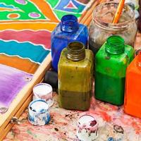 paintbrush and bottles with dyes photo