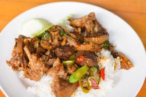 Rice topped with stir-fried duck and basil photo