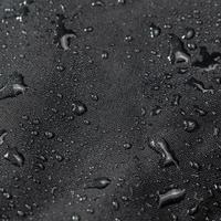 dark gray waterproof hydrophobic cloth closeup with water drops photo