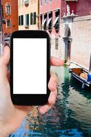 tourist photographs of canal, boats in Venice photo