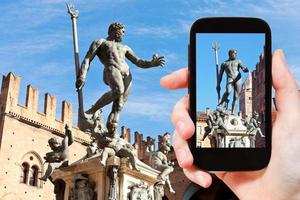 tourist snapping photo of fountain of neptune