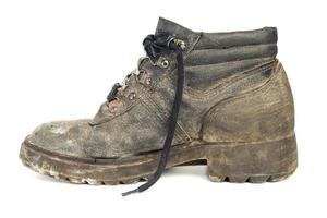 worn-out old work boot, isolated on white background with shadow photo